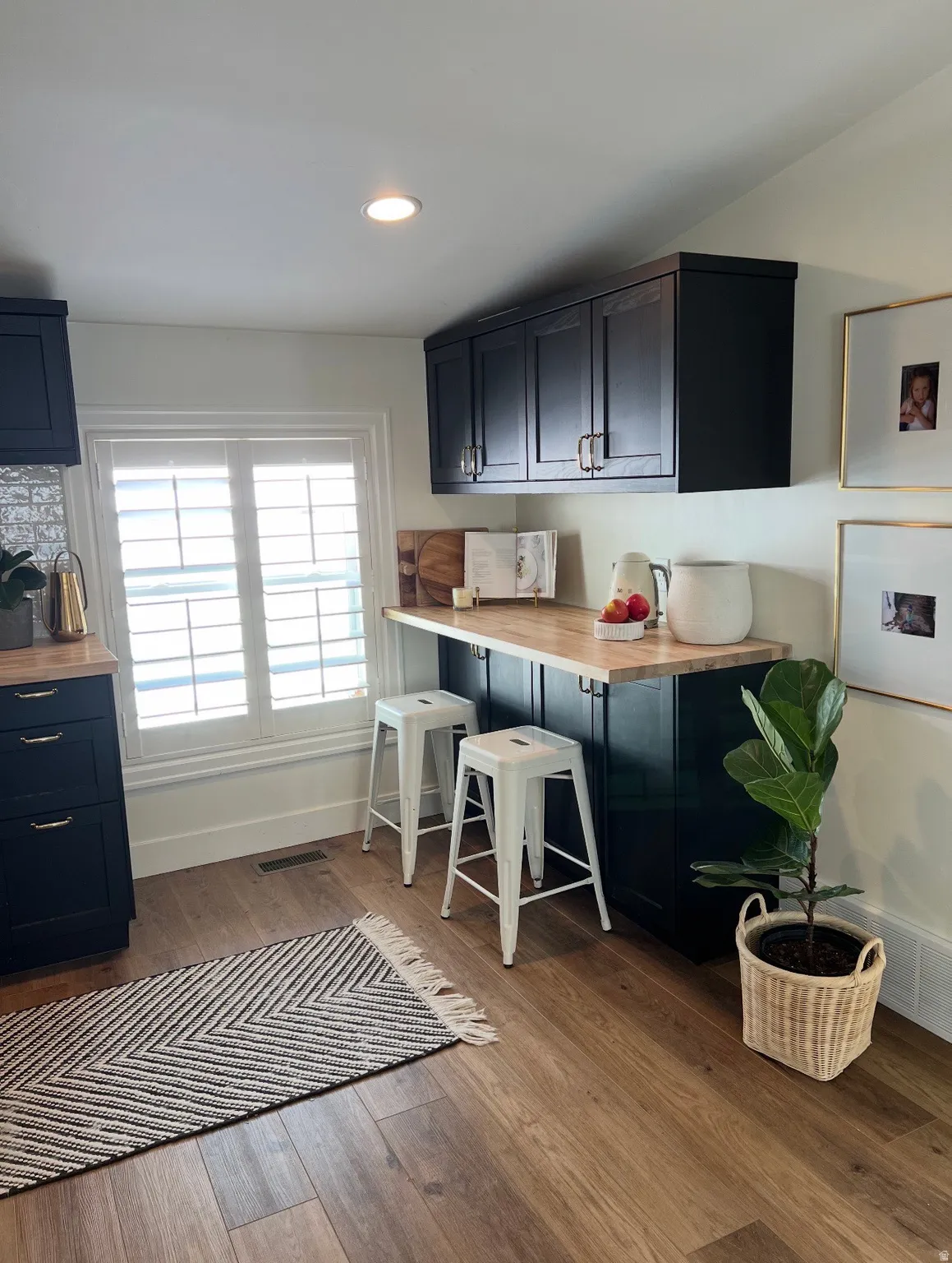 Recessed lighting illuminates wood-finish flooring
