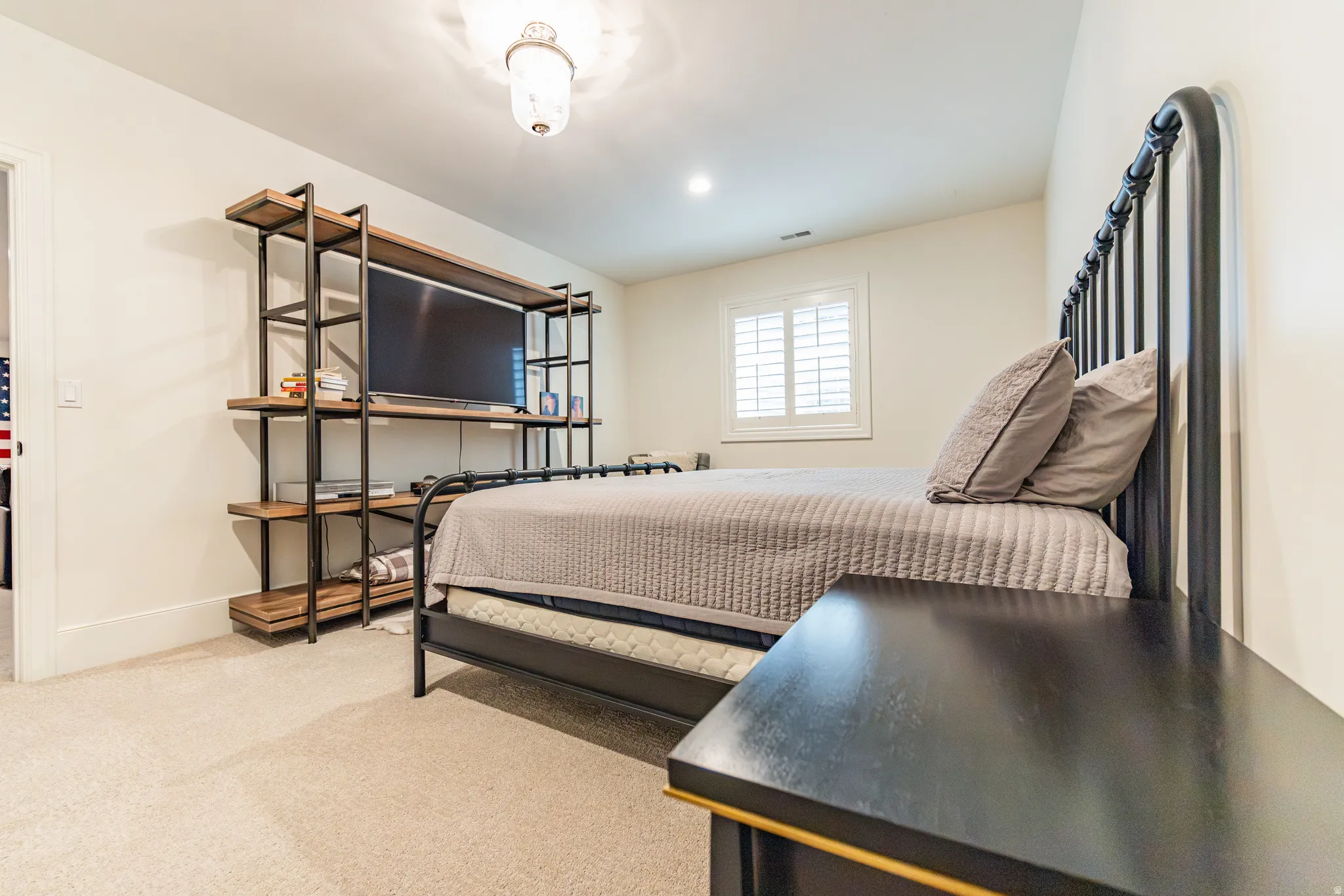 Wall-to-wall carpeting, window with plantation shutters, recessed lighting, and ceiling-mounted light fixture