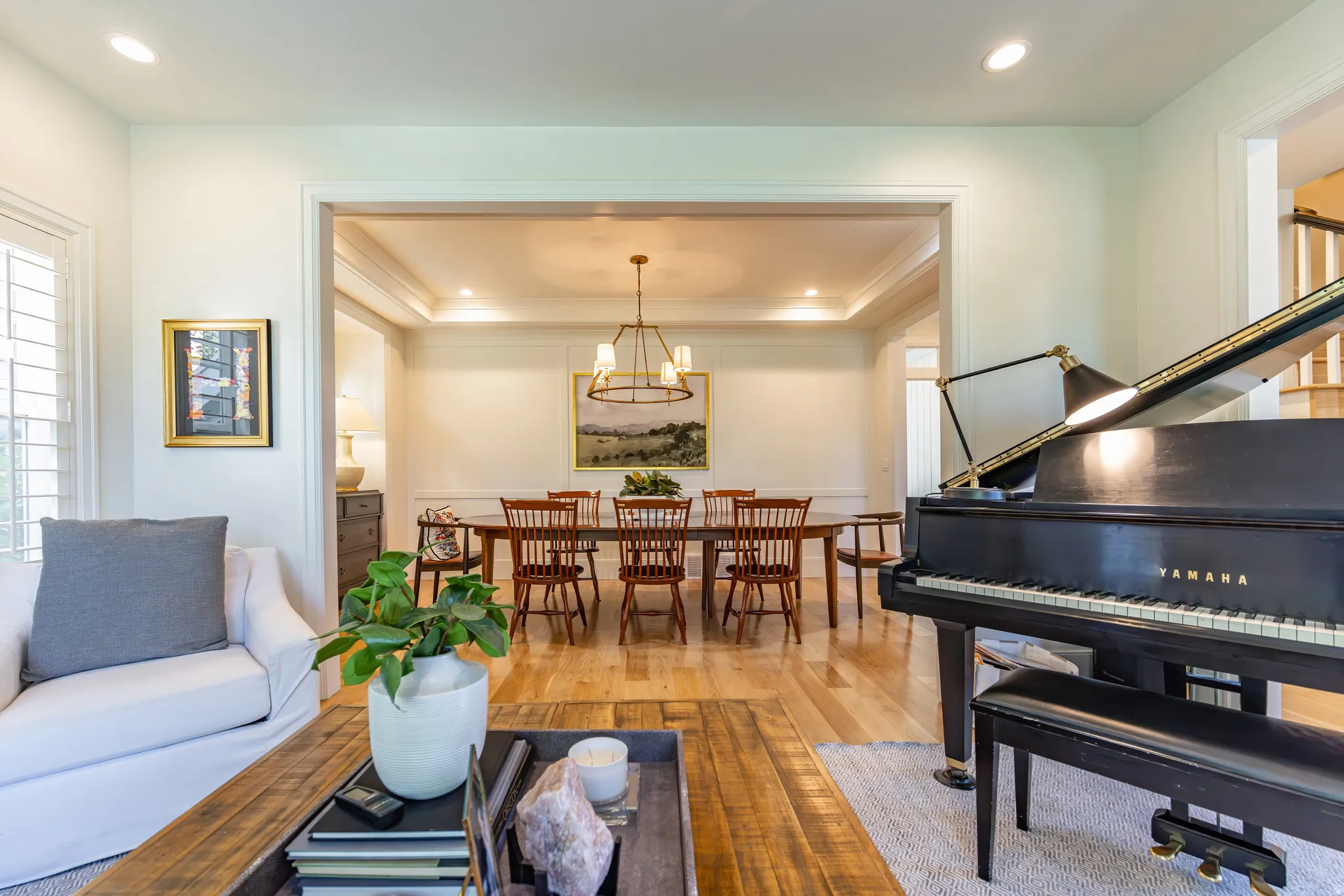 Hardwood flooring throughout, recessed lighting, crown molding, and a chandelier-style light fixture
