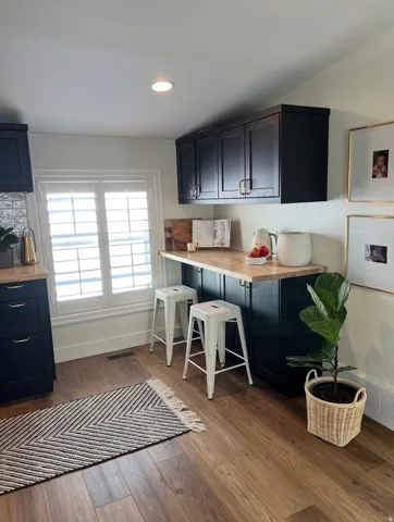 Recessed lighting illuminates wood-finish flooring