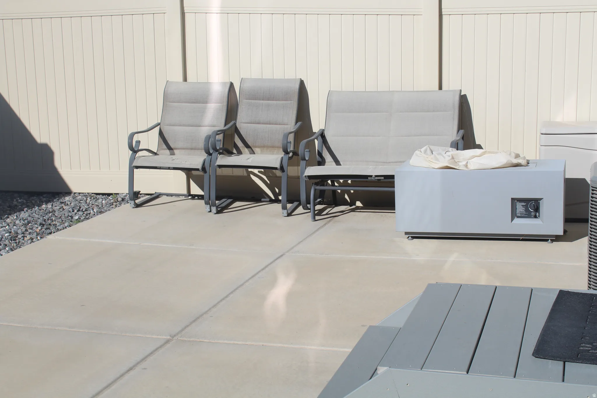 Poured concrete patio with a light-toned privacy fence