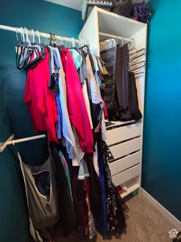 Built-in closet system featuring multiple hanging rods, integrated shelving, and drawer storage