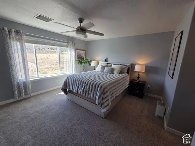 Ceiling fan, wall-to-wall carpeting, large window, neutral wall paint, and recessed lighting