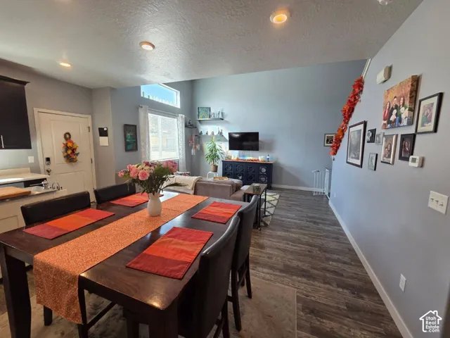 Vaulted ceiling with recessed lighting, transom windows, wood-finish flooring, and a built-in kitchen counter