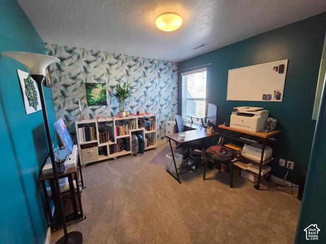 Carpeted flooring, recessed lighting, built-in shelving, and window with blinds