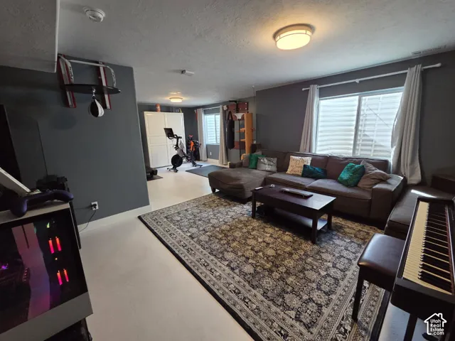 Recessed lighting, light-toned flooring, and window treatments