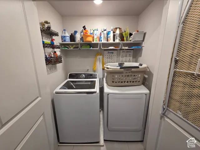 Dedicated laundry area featuring a white washing machine and a white dryer