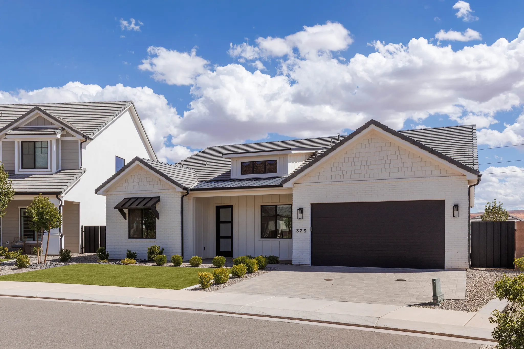 Contemporary white brick exterior with dark trim accents