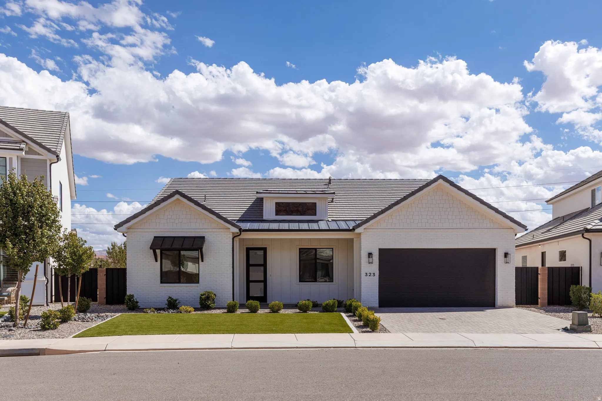 White exterior with dark trim and a dark gray roof