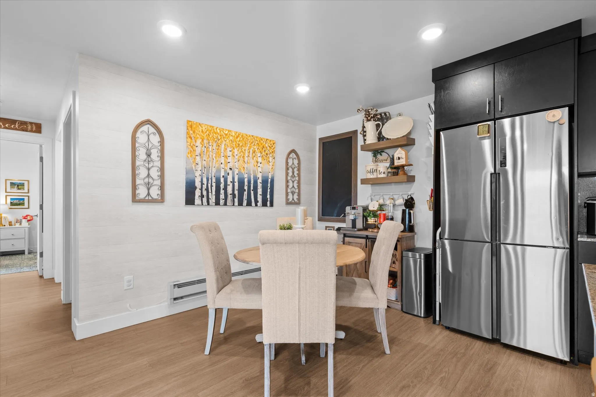 Wood-finish flooring throughout, recessed ceiling lighting, and light-toned walls