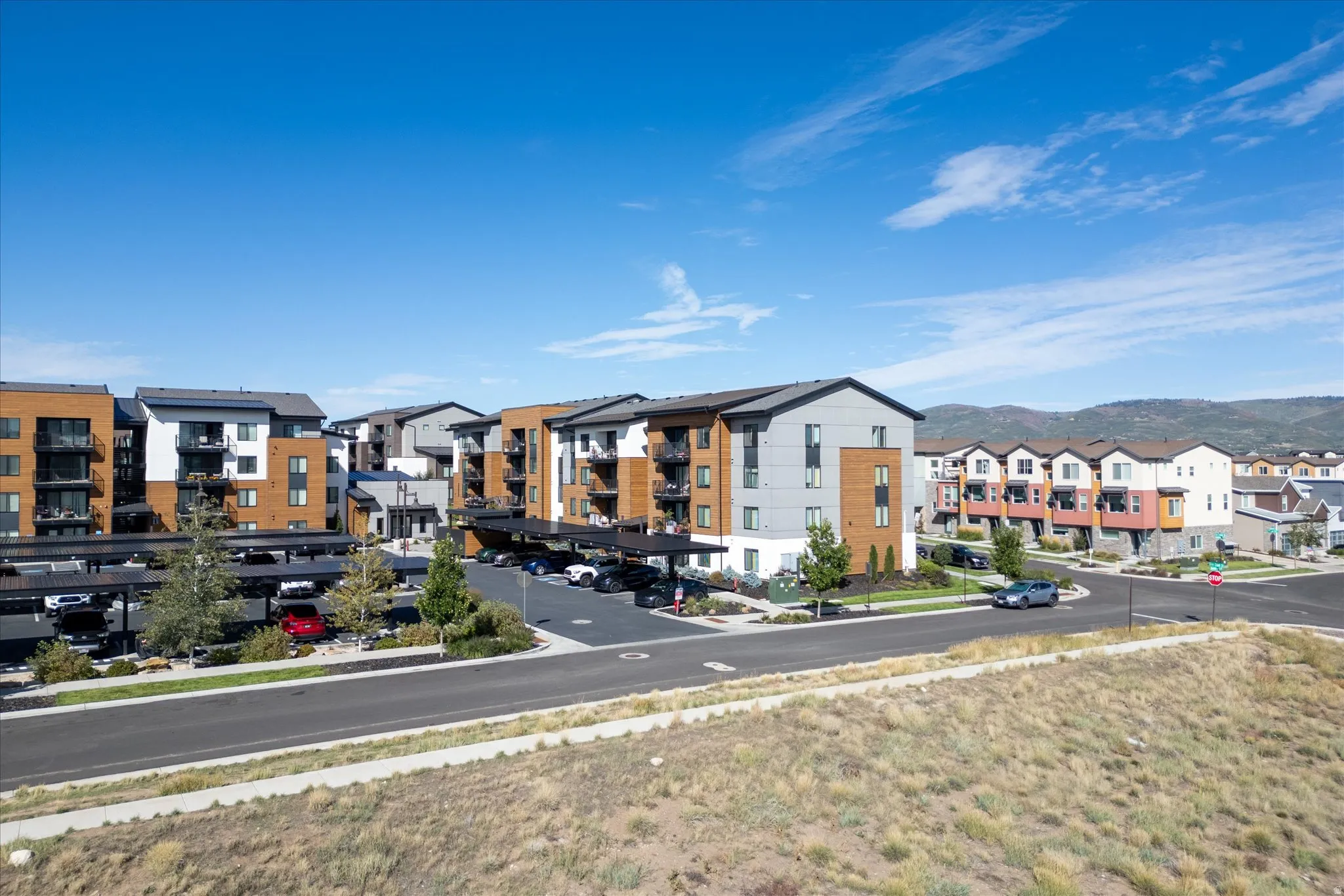 Contemporary multi-story buildings featuring varied facades and private balconies