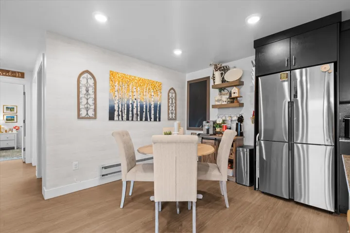 Wood-finish flooring throughout, recessed ceiling lighting, and light-toned walls