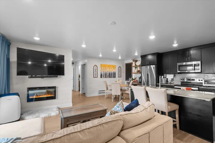 Living area featuring an electric fireplace and wood-finish flooring