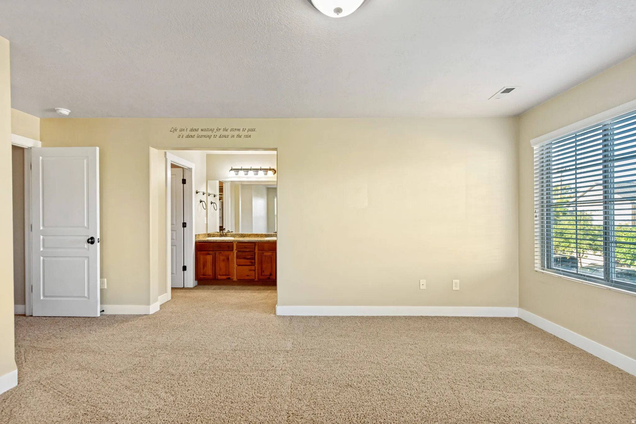 Carpeted flooring, recessed lighting, and a window with blinds