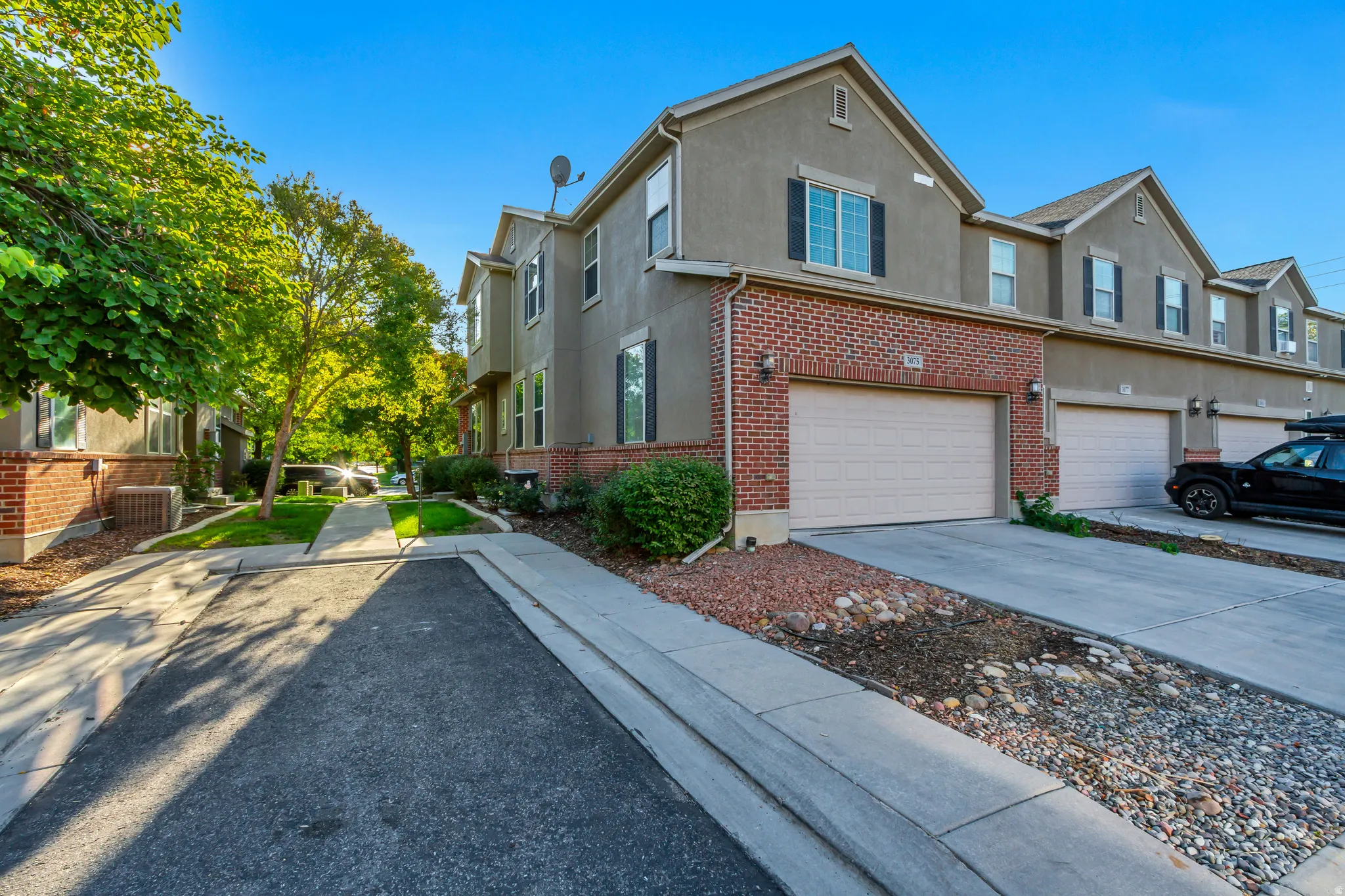 Stucco and brick exterior with attached garage
