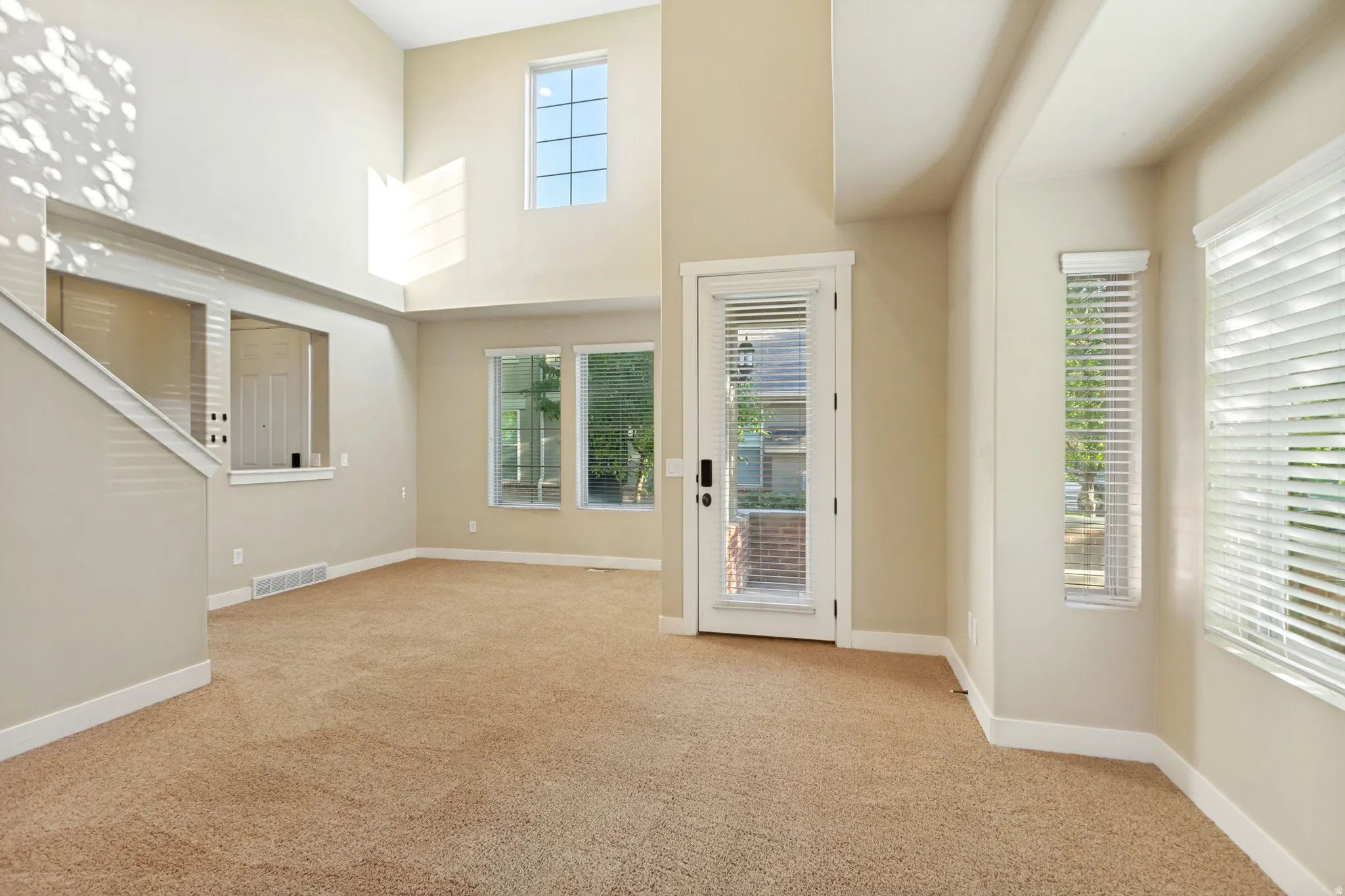 Voluminous ceilings, multiple windows, and a glass-paneled door