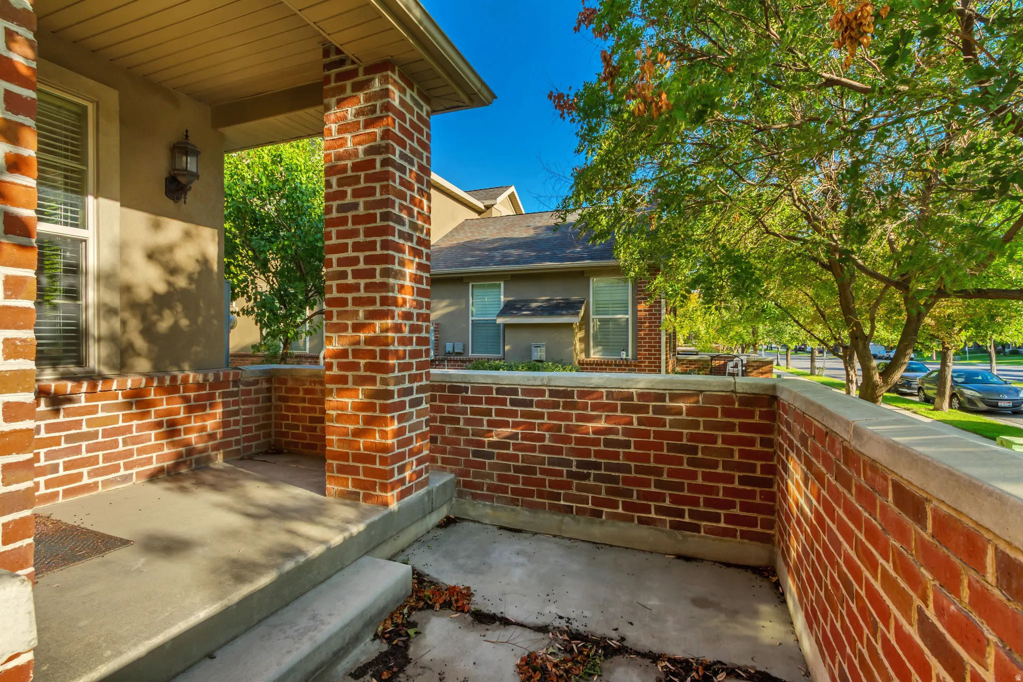 Brick exterior with a covered porch, solid brick column, and matching brick planter box