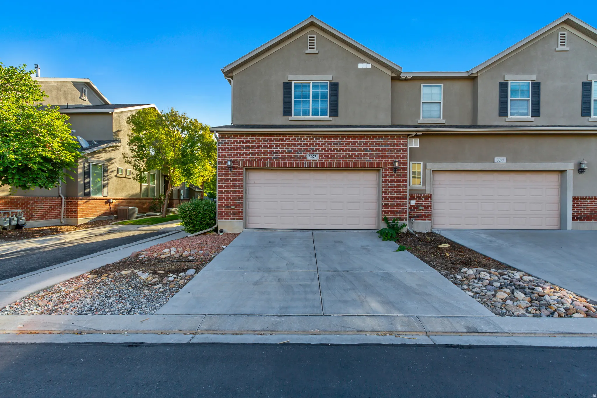 Stucco and brick exterior with a two-car garage