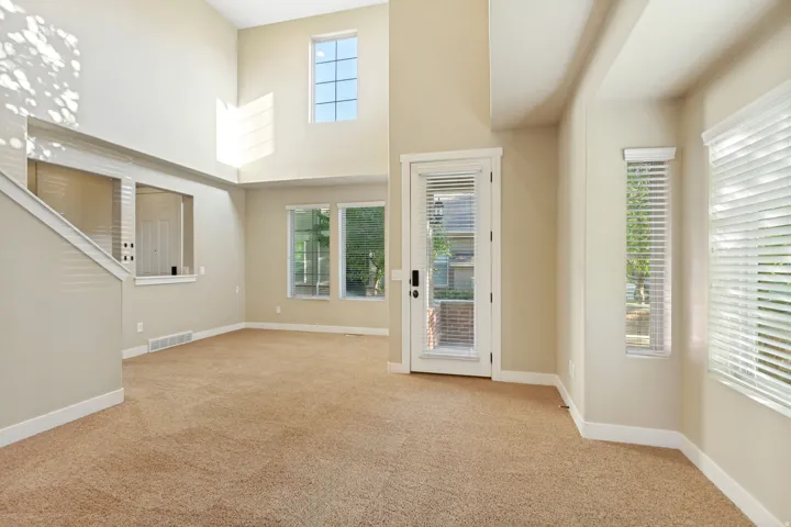 Voluminous ceilings, multiple windows, and a glass-paneled door