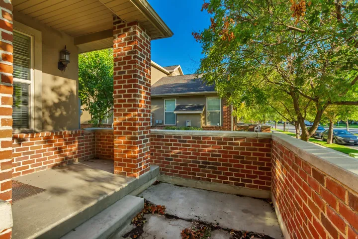 Brick exterior with a covered porch, solid brick column, and matching brick planter box