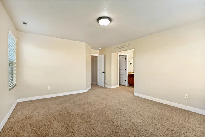 Neutral wall tones, recessed window, and brown carpeting