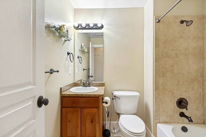 Wood-finish vanity with an undermount sink and granite-finish countertop