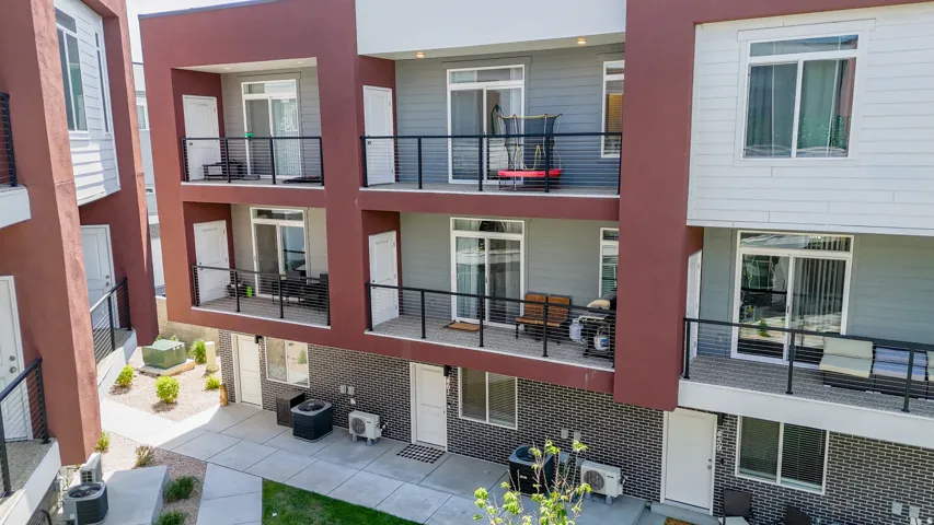 Contemporary multi-story exterior with private balconies featuring black railings
