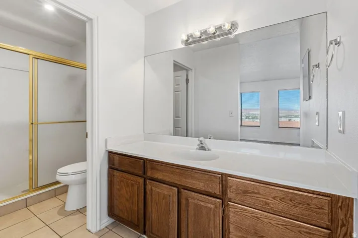 Wood-finish vanity with an integrated sink and countertop