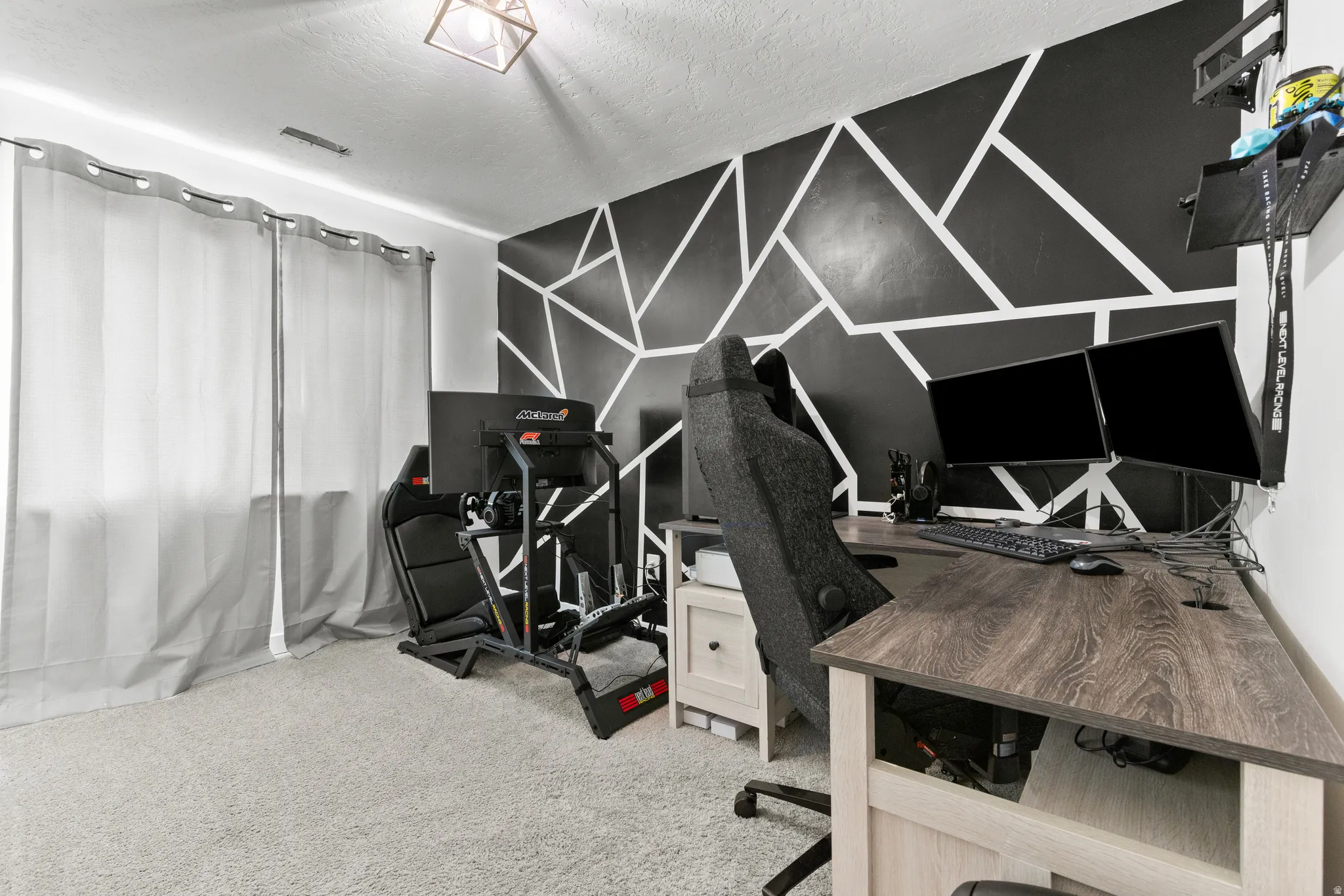 Geometric accent wall with light carpet flooring
