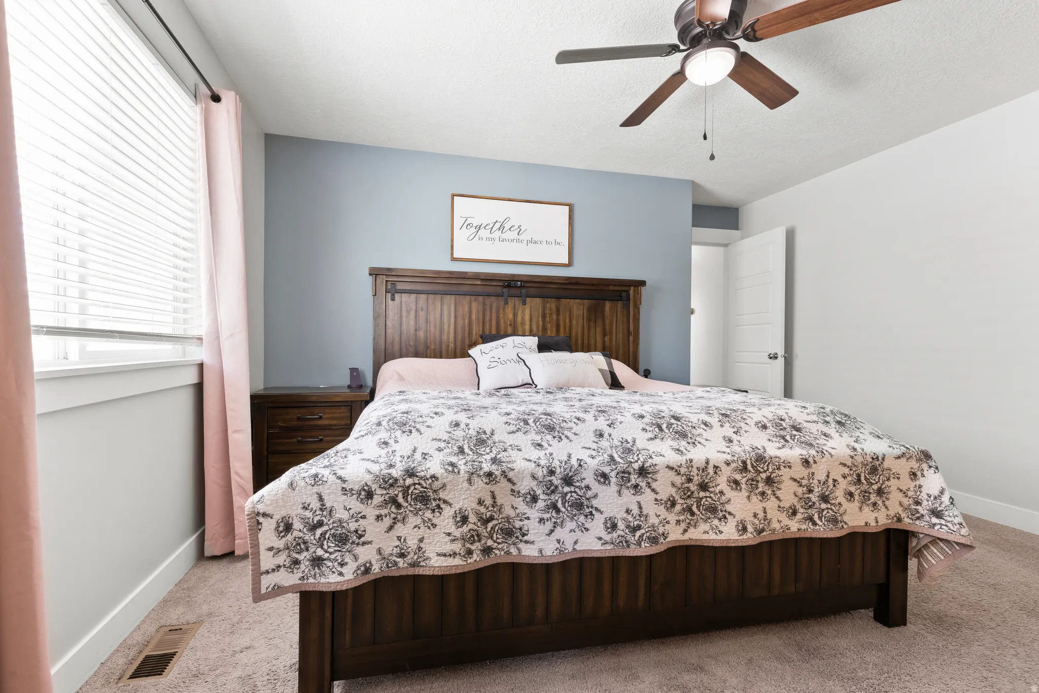 Recessed lighting, ceiling fan with wood-finish blades, and window with blinds
