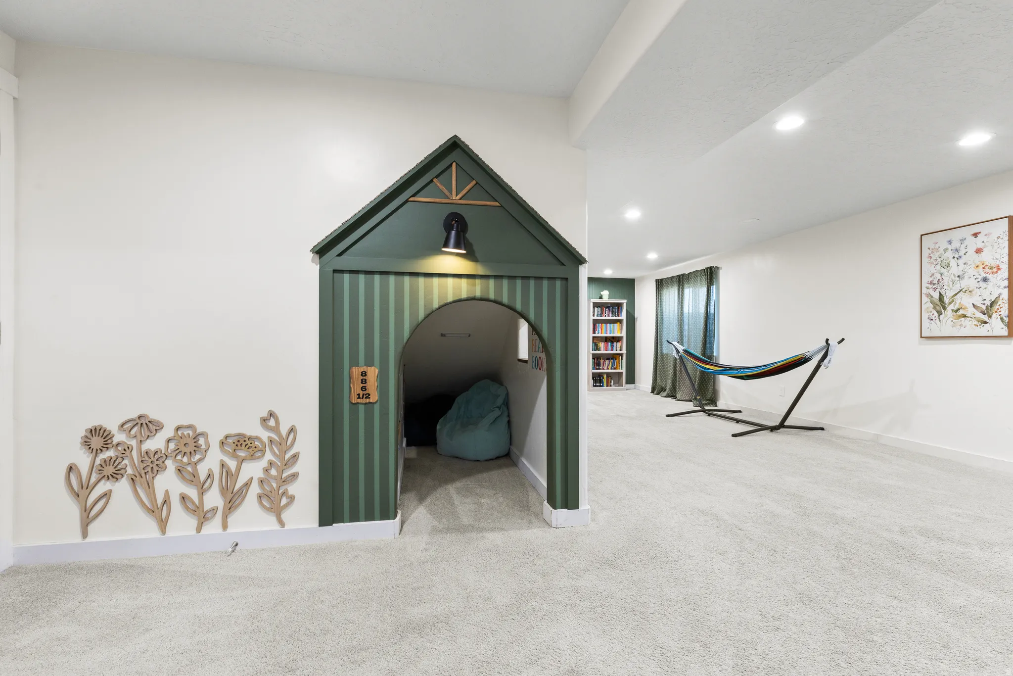Built-in archway feature, recessed lighting, wall-to-wall carpeting, built-in shelving, decorative wall accents