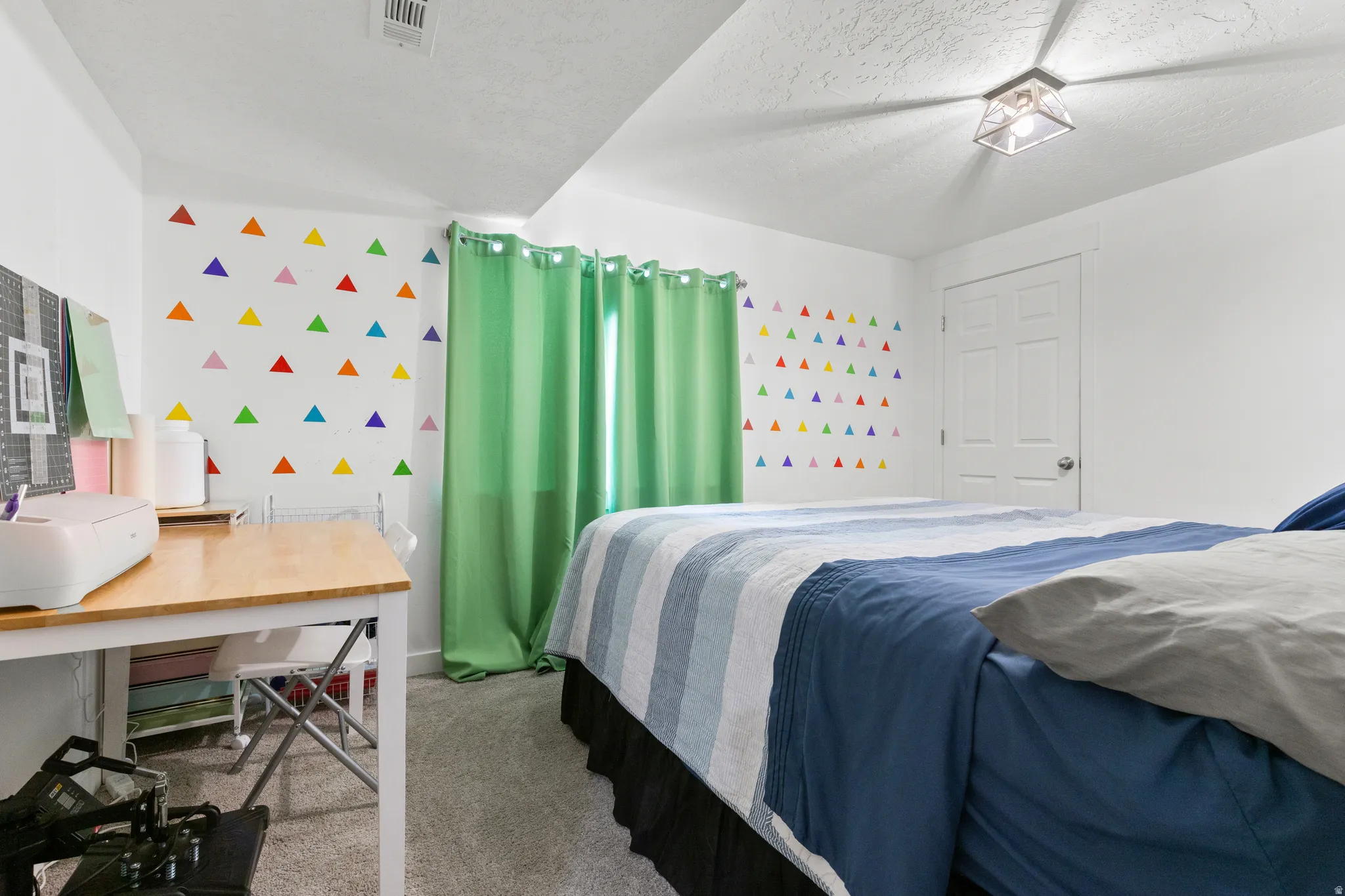 Carpeted flooring with white painted walls and a flush-mount ceiling light fixture