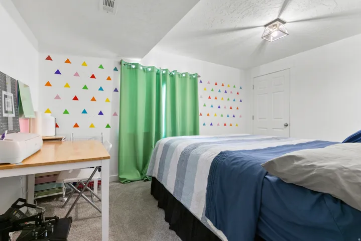 Carpeted flooring with white painted walls and a flush-mount ceiling light fixture