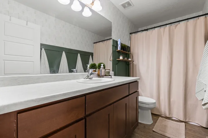 Vanity with a single basin and a white countertop