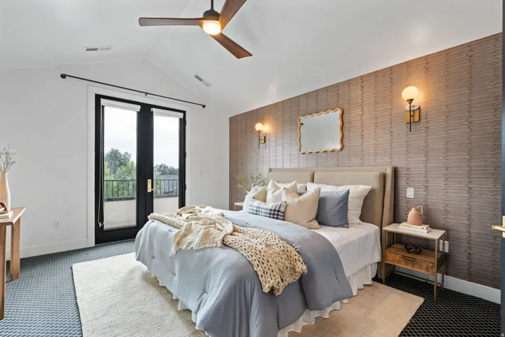 Primary bedroom w/french doors leading to balcony