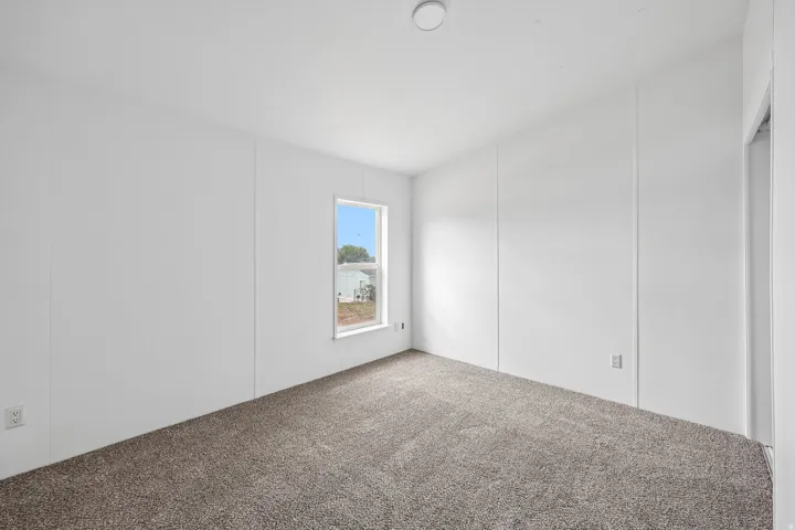 Neutral wall finishes, recessed lighting, and carpeted flooring