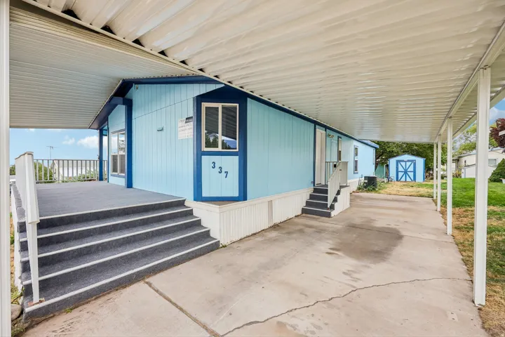 Covered carport with concrete driveway