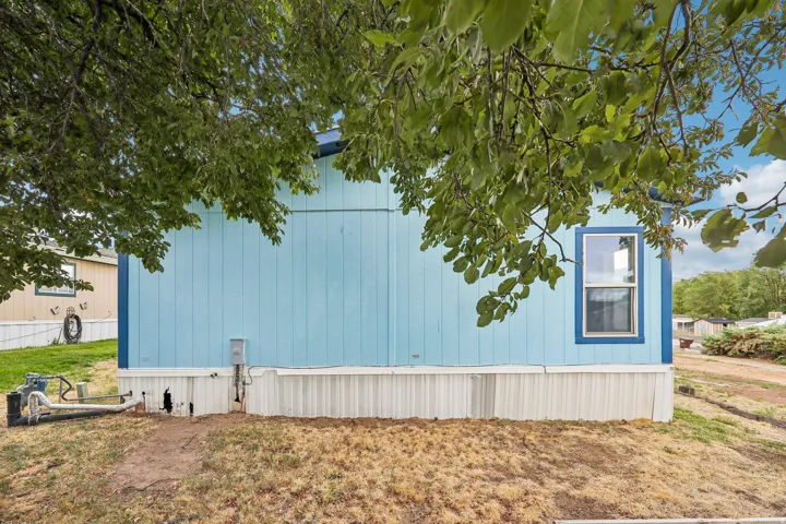 Blue siding with white trim and a single-pane window