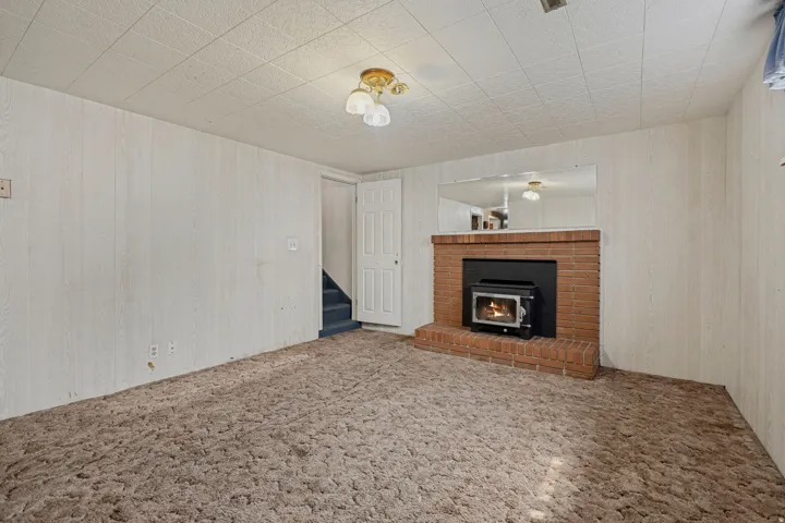 Wood-burning stove set within a brick hearth and surround