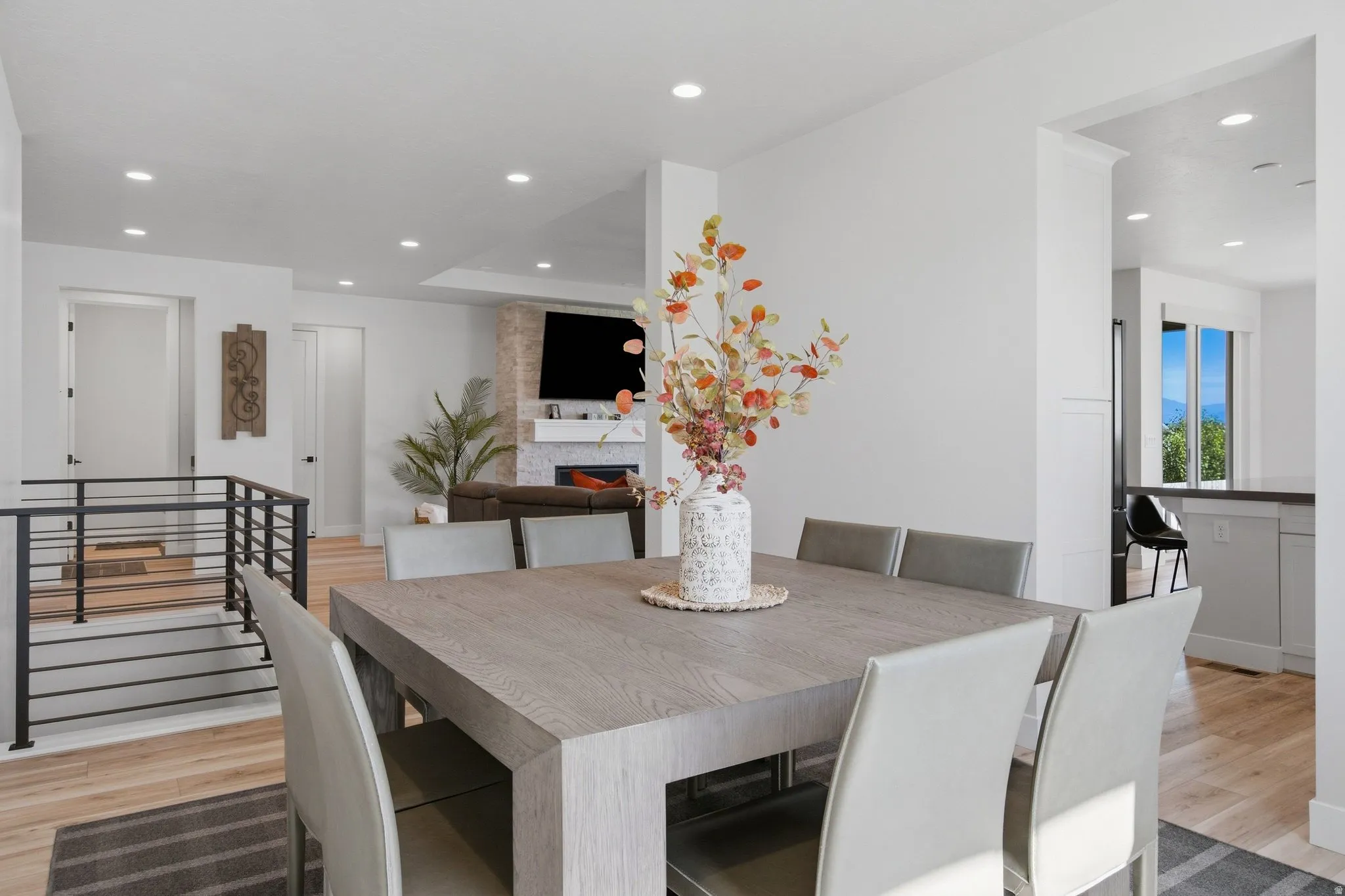 Recessed lighting, LVP wood-finish flooring, with open-concept design.