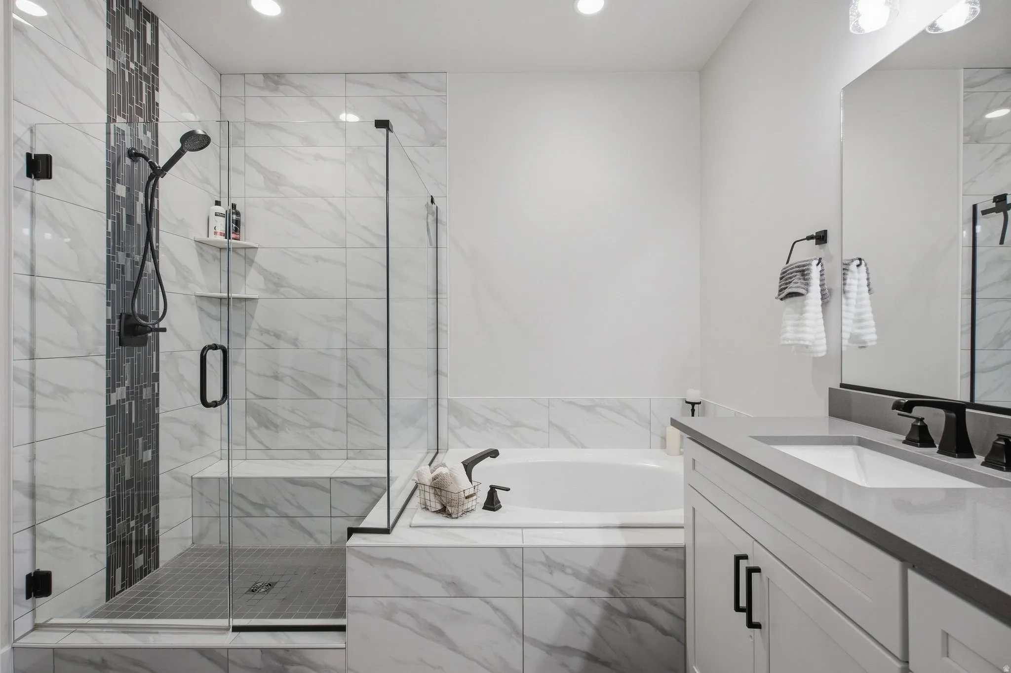 Primary En-suite with walk-in shower with glass enclosure, built-in bench, and garden tub.