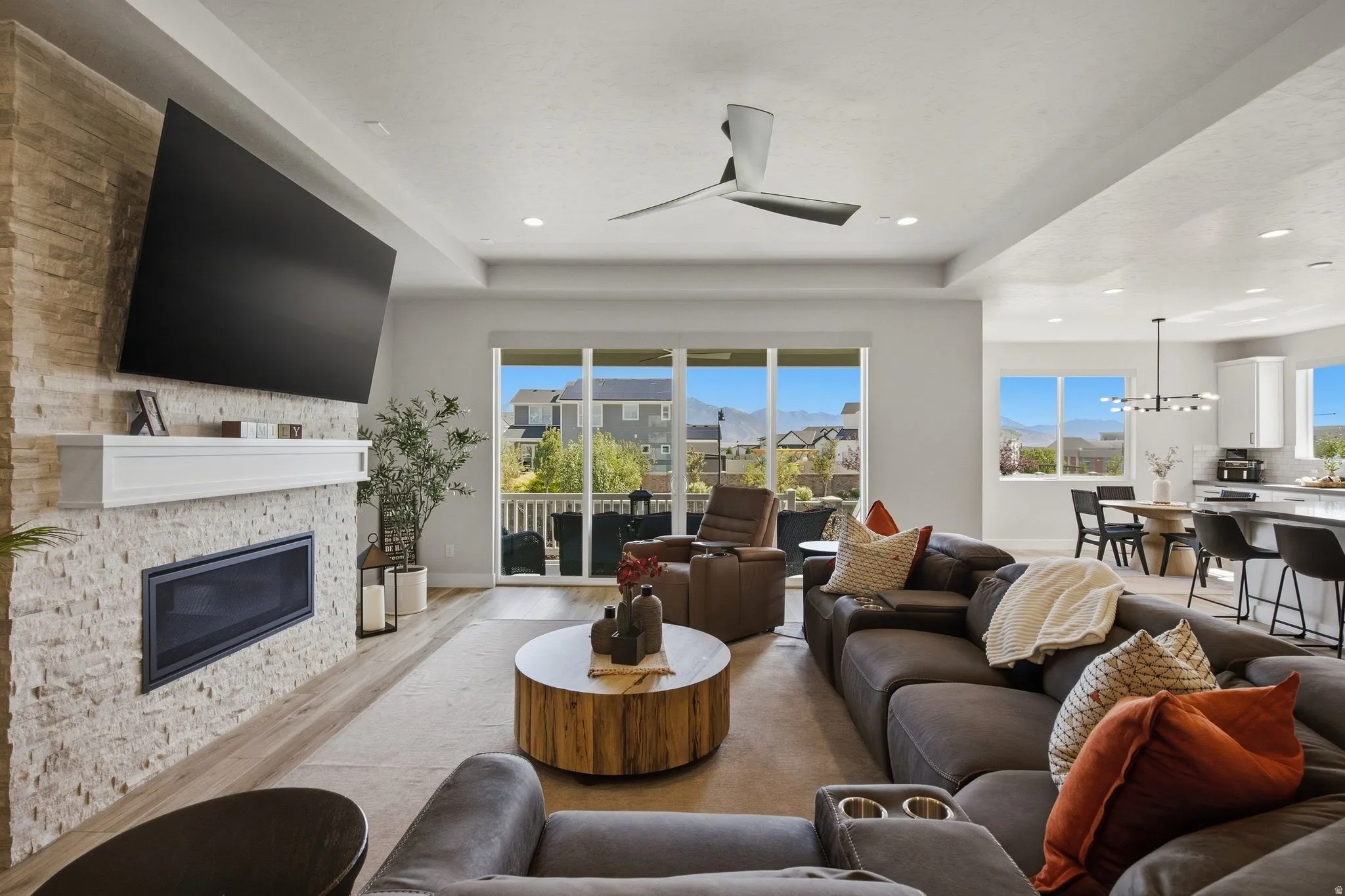 Living area featuring a floor-to-ceiling stone-faced fireplace with an integrated firebox and mantel.