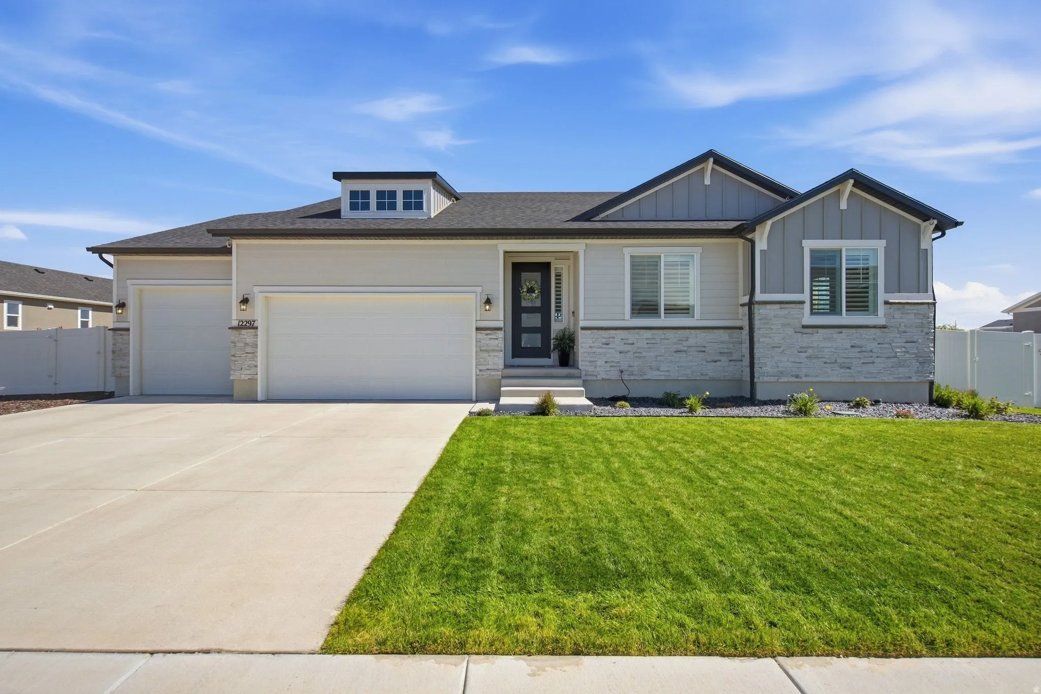 Contemporary exterior with mixed material facade, featuring stone accents and siding.