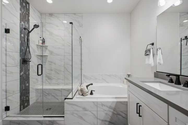 Primary En-suite with walk-in shower with glass enclosure, built-in bench, and garden tub.