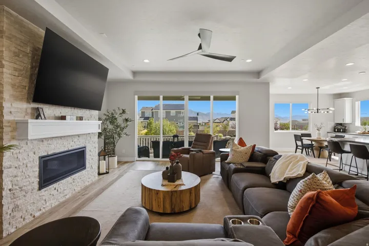Living area featuring a floor-to-ceiling stone-faced fireplace with an integrated firebox and mantel.