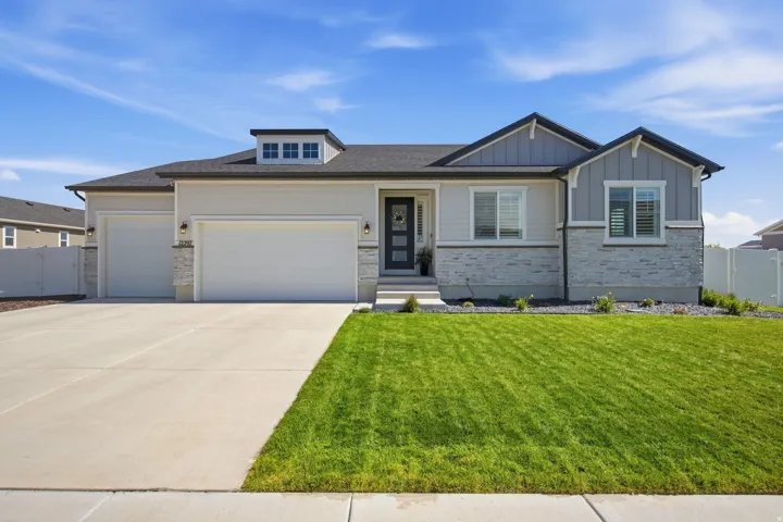 Contemporary exterior with mixed material facade, featuring stone accents and siding.