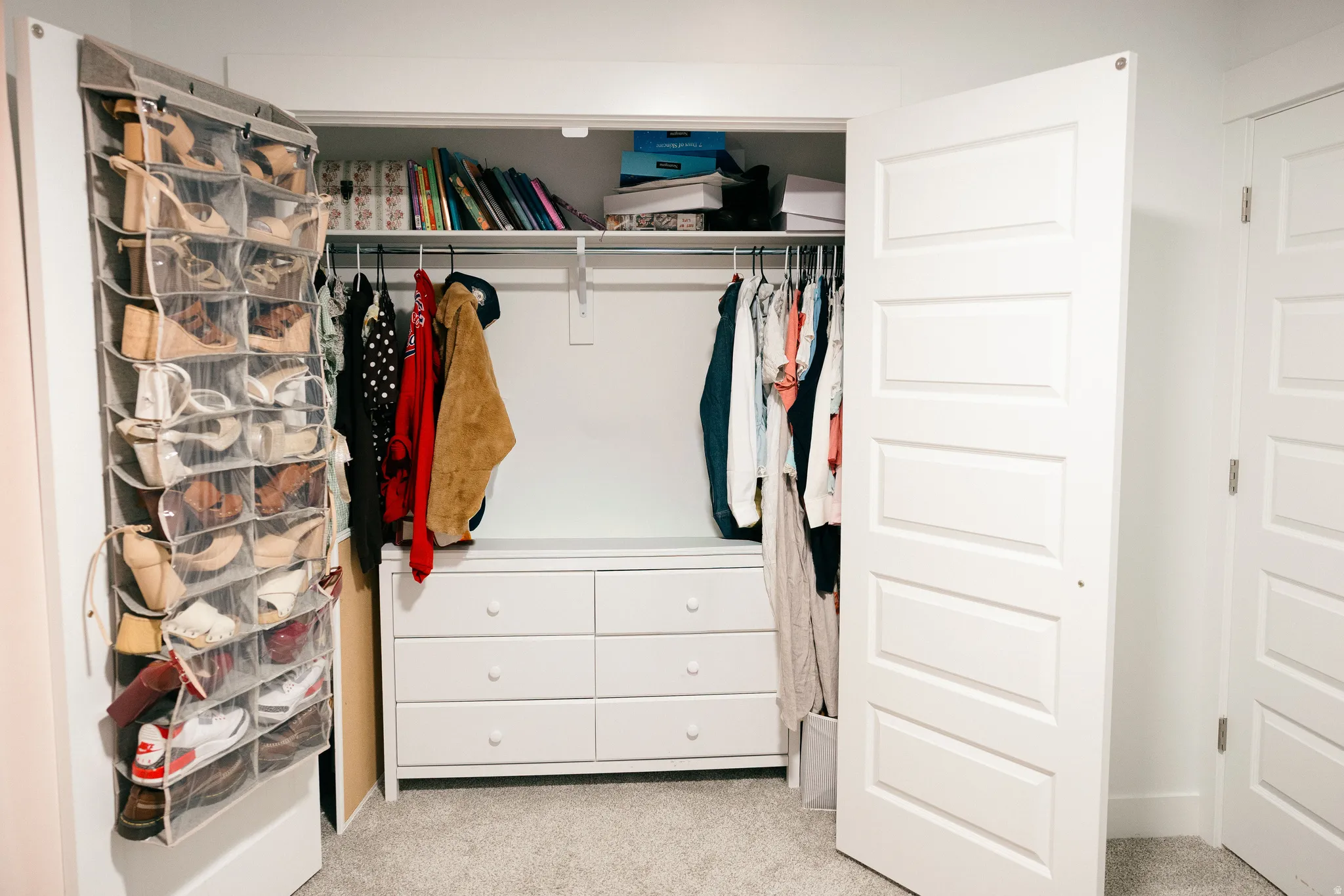 Built-in dresser with six drawers, upper shelving, and closet rod for hanging storage