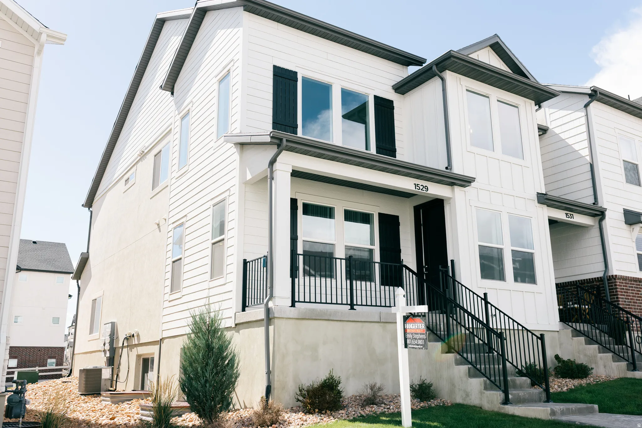 White siding exterior with black shutters and dark gray trim