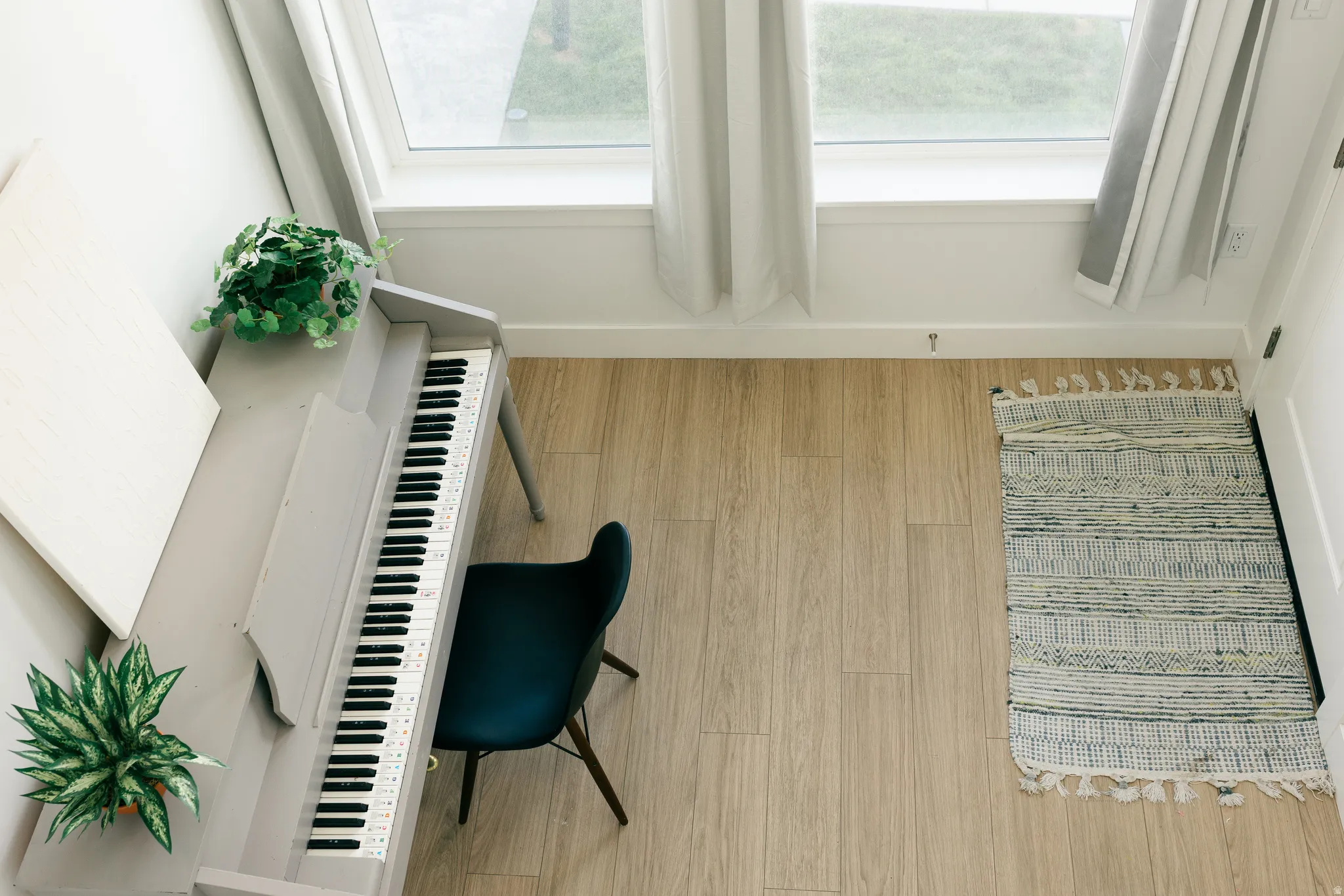 Wood-finish flooring with abundant natural light from large windows