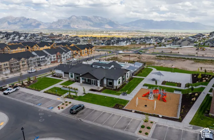 Community amenities featuring a modern recreation center, outdoor swimming pool, and playground area with a shaded seating zone